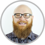 Portrait of a smiling man wearing glasses and a beard, used as a customer testimonial.